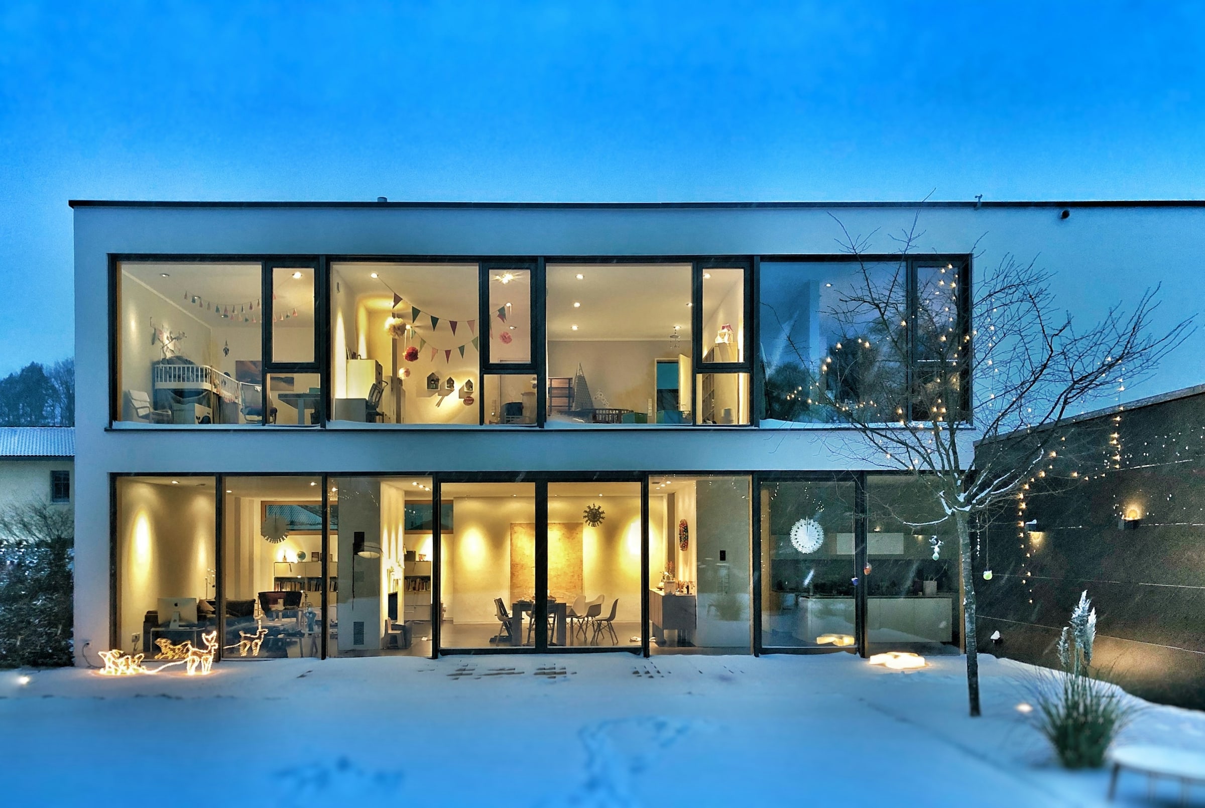 A crystalline glass volume against a spare landscape